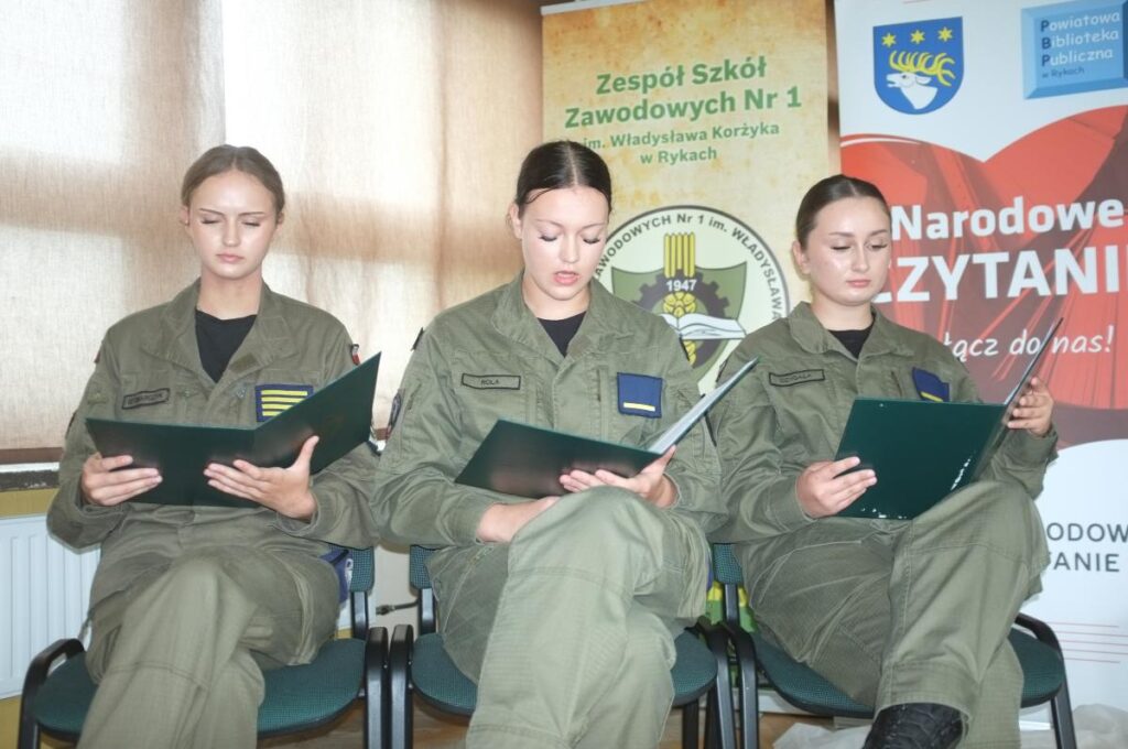 zdjęcie na tle dekoracji narodowe czytanie 2026 - czytają 3 osoby